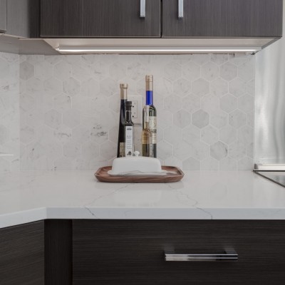 chrome pulls dark cabinets backsplash hexagon quartz counter