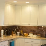 Concealed kitchen outlet idea where the outlets are on the underside of the upper cabinets