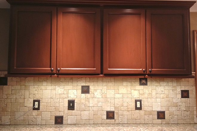 Kitchen outlets with matching faceplates to better blend with the backsplash